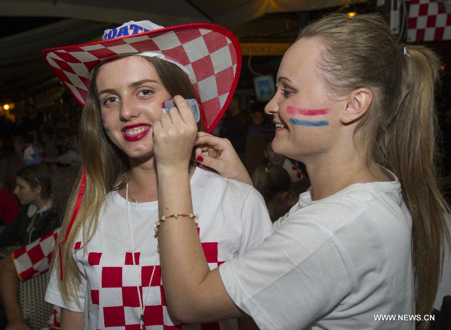 Croatian soccer fans cheer on their team during World Cup opener