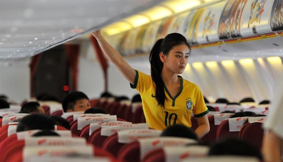 Stewardesses in Brazilian soccer jerseys