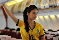 Stewardesses in Brazilian soccer jerseys