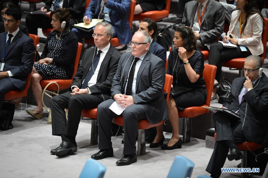 Dutch Foreign Minister Frans Timmermans (C) looks on as the United Nations Security Council vote on a draft resolution regarding the Malaysian Airlines MH17 crash, at the UN headquarters in New York, on July 21, 2014. The UN Security Council on Monday approved a resolution demanding safe and unrestricted access to the MH17 crash site, and calling for full cooperation with the international investigation. (Xinhua/Niu Xiaolei)