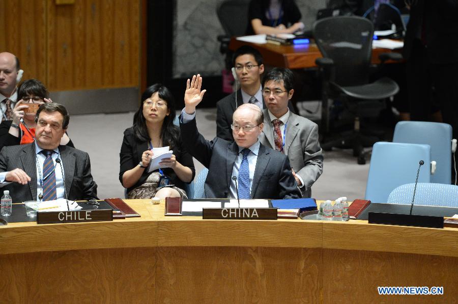 China's permanent representative to the United Nations Liu Jieyi(C) votes for a United Nations Security Council draft resolution regarding the Malaysian Airlines MH17 crash, at the UN headquarters in New York, on July 21, 2014. The UN Security Council on Monday approved a resolution demanding safe and unrestricted access to the MH17 crash site, and calling for full cooperation with the international investigation. (Xinhua/Niu Xiaolei)