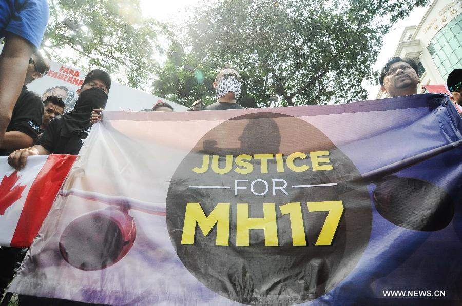 Protesters shout slogans demanding justice for the victims of Malaysia Airlines Flight MH17 at a rally held by Malaysia's ruling United Malays National Organization (UMNO)'s youth wing outside the Russian embassy and United Nations office in Kuala Lumpur July 22, 2014. Rallies are held by UMNO's youth wing outside Russian and Ukrainian embassies in Kuala Lumpur, demanding a justice investigation of the crash of Malaysian Airlines Flight MH17. (Xinhua/Chong Voon Chung)