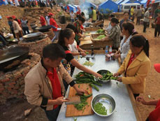 Volunteers prepare breakfast at temporary resettlement in quake-hit area