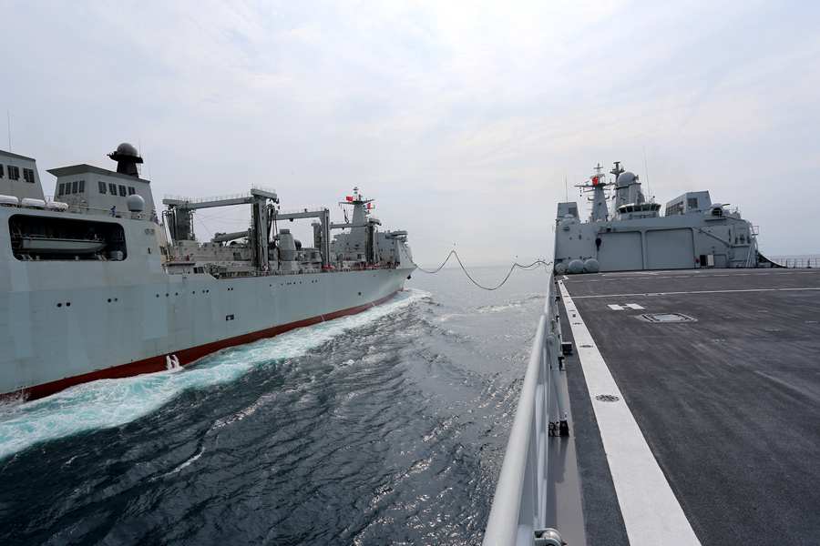 Landing ship executes replenishment-at-sea with new comprehensive supply ship