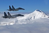 J-11B fighter jets patrol snow-covered mountain area
