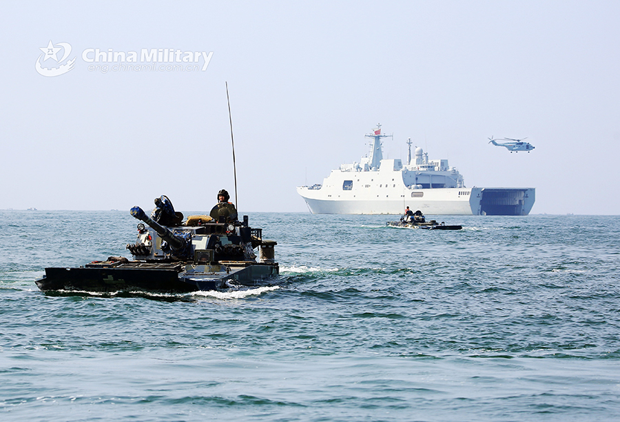 Amphibious armored vehicles in beach raid training