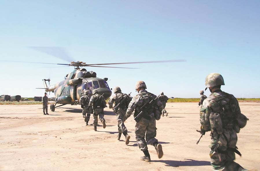 Soldiers assigned to an army aviation brigade under the PLA 81st Group Army queue to board a transport helicopter for a recent real combat training exercise near the Bohai Bay. (eng.chinamil.com.cn/Photo by Wang Leiqian,Xu Yang and Lu Zhenbao)