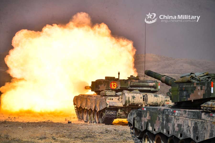 A main battle tank attached to an armored brigade under the PLA 73rd Group Army fires toward a simulated enemy during a live-fire combat drill in northwest China’s Gobi desert on October 22, 2020. (eng.chinamil.com.cn/Photo by Liu Zhiyong)