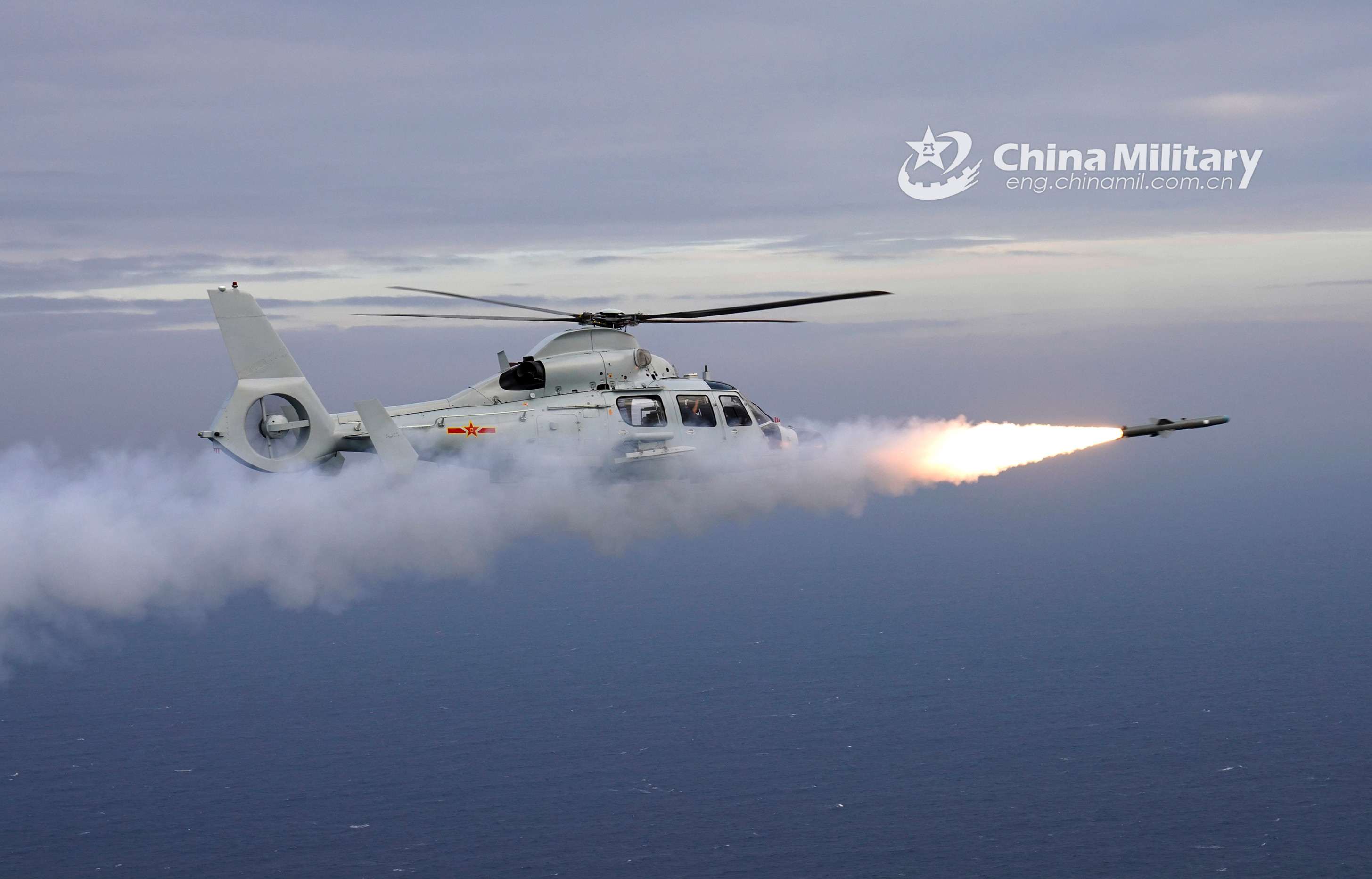 A ship-borne Z-9 helicopter attached to an aviation regiment with the navy under the PLA Southern Theater Command fires a missile at mock target during a live-fire training exercise on December 11, 2020. (eng.chinamil.com.cn/Gao Hongwei)