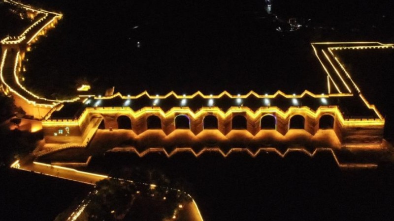 Jiumenkou Great Wall lit up as night falls in summer