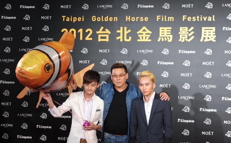 Hsu Chao-jen (C), director of the film "Together", and actors Huang Shao-yang (L) and Wu Chien attend the opening ceremony of the Taipei Golden Horse Film Festival in Taipei, southeast China's Taiwan, Nov. 9, 2012. "Together" is the opening film of the Taipei Golden Horse Film Festival, which kicked off Friday in Taipei. (Xinhua/Yin Bogu)