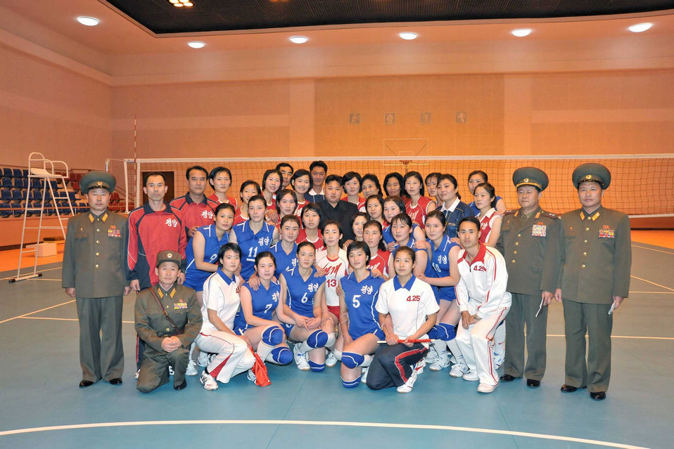 Kim Jong Un, top leader of the Democratic People's Republic of Korea (DPRK) and his wife Ri Sol Ju poses with members of women's volleyball, according to the country's official news agency KCNA's report on Nov.7, 2012. (KCNA)