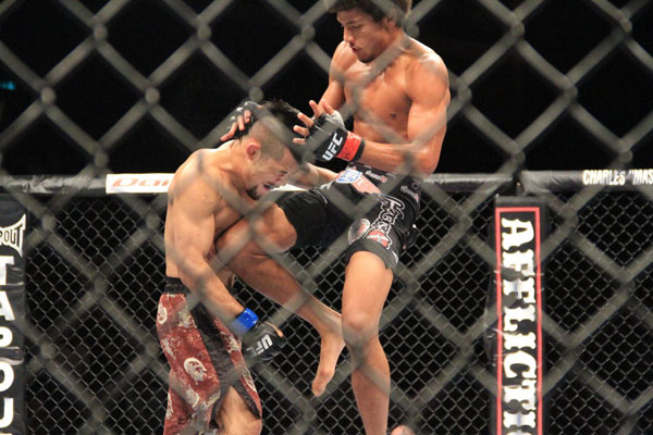 Alex Caceres delivers a flying knee to his Japanes opponent Motonobu Tezuka at UFC Macao, November 10, 2012. [Photo: CRIEnglish.com/Xu Weiyi] 