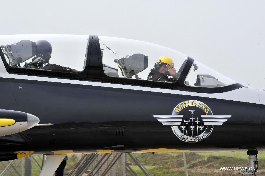 A pilot of Breitling Jet Team, the largest civilian aerobatic team in Europe, waves after a test flight in Zhuhai, south China's Guangdong Province, Nov. 12, 2012. The 9th China International Aviation and Aerospace Exhibition will kick off on Tuesday in Zhuhai. (Xinhua/Liang Xu) 