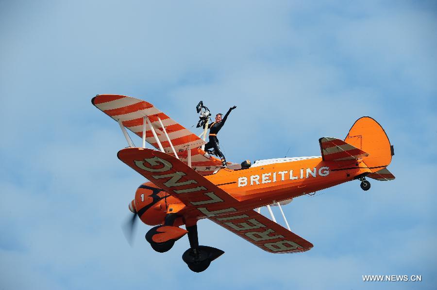 Members of Breitling Wingwalkers, a famous European aerobatic team, perform during a test flight in Zhuhai, south China's Guangdong Province, Nov. 11, 2012. The 9th China International Aviation and Aerospace Exhibition will kick off on Tuesday in Zhuhai. Breitling Wingwalkers is known for its acrobats who perform on the wings of Boeing Stearman biplanes in mid-air. (Xinhua/Yang Guang)  