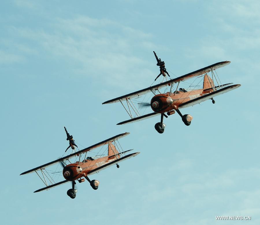 Members of Breitling Wingwalkers, a famous European aerobatic team, perform during a test flight in Zhuhai, south China's Guangdong Province, Nov. 11, 2012. The 9th China International Aviation and Aerospace Exhibition will kick off on Tuesday in Zhuhai. Breitling Wingwalkers is known for its acrobats who perform on the wings of Boeing Stearman biplanes in mid-air. (Xinhua/Yang Guang) 