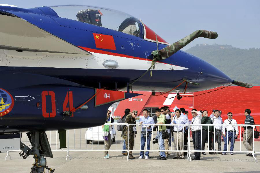 Visitors view the J-10 Fighter of China Air Force during the opening ceremony of the 9th China International Aviation and Aerospace Exhibition in Zhuhai, south China's Guangdong Province, Nov. 13, 2012. About 650 exhibitors in the aviation and aerospace field took part in the six-day event. (Xinhua/Liang Xu)  