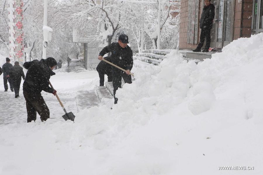 Residents clean snow on a raod in Hegang, northeast China's Heilongjiang Province, Nov. 13, 2012. Snowstorms in recent days have affected road traffic and caused difficulties to local people in northeast China. (Xinhua/Fang Baoshu) 