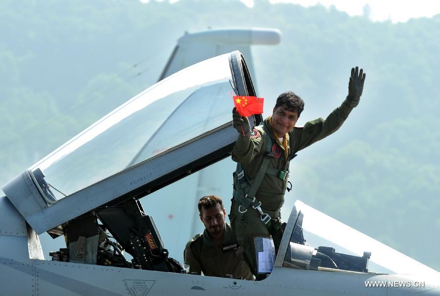 A Pakistani pilot of FC-1 fighter jet greets the audience during the 9th China International Aviation and Aerospace Exhibition in Zhuhai, south China's Guangdong Province, Nov. 13, 2012. (Xinhua/Liu Dawei) 