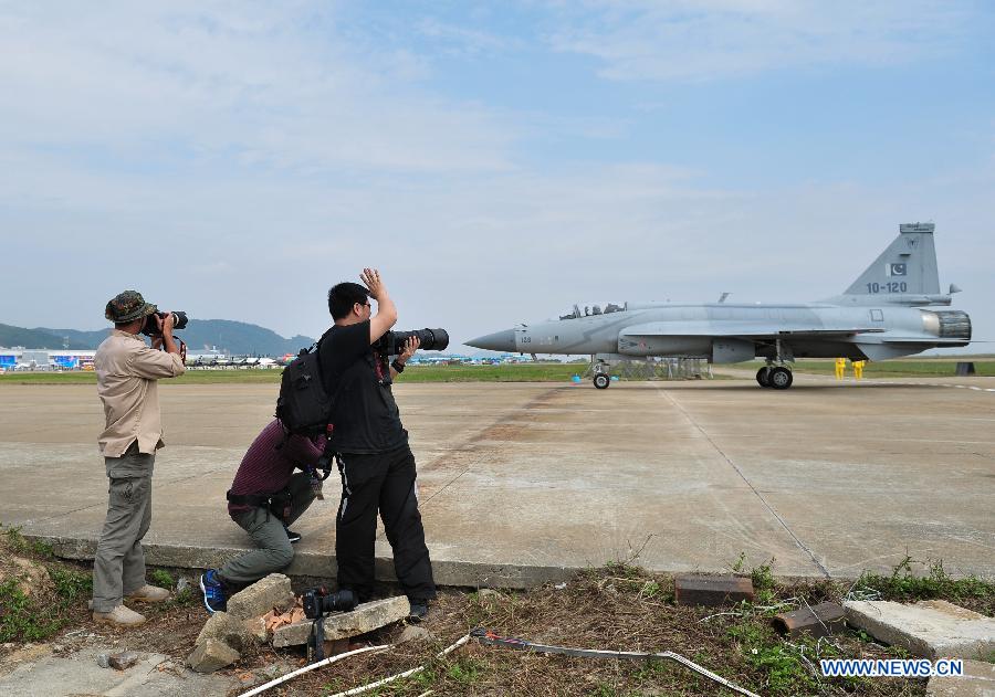 Photographers take photo of the JF-17 plane from Pakistan Air Force after it finished flight display during the 9th China International Aviation and Aerospace Exhibition in Zhuhai, south China's Guangdong Province, Nov. 11, 2012. The exhibition has attracted a large number of photograghers. Some of them are from media, some are from aviation industry corporations and others are big fans of aviation. (Xinhua/Yang Guang)