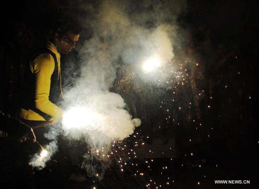 Pakistani Hindus play with fireworks to celebrate the Hindu festival of Diwali, in eastern Pakistan's Lahore, on Nov. 13, 2012. People light lamps and offer prayers to the goddess of wealth Lakshmi in the Hindu festival of Diwali, the festival of lights, which falls on Nov. 13 this year. (Xinhua/Sajjad)