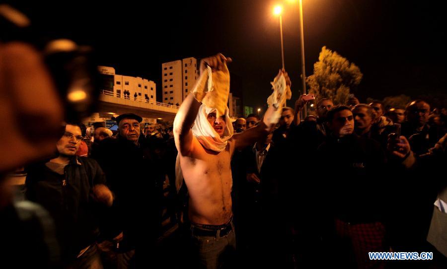Protesters take part in a demonstration following an announcement that Jordan would raise fuel prices in Amman, Jordan, Nov. 13, 2012. At least ten policemen were shot and four other civilians injured during riots across Jordan late Tuesday and Wednesday after the government ended fuel subsidies, the state-run Petra news agency reported. (Xinhua/Mohammad Abu Ghosh)