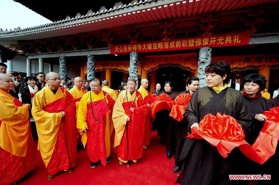 Monks and visitors attend the ribbon-cutting ceremony as the renovation of the Mahavira Hall in Tianxin Yongle Temple finishes in Wuyishan, southeast China's Fujian Province, Nov.18, 2012. Originated from Tang Dynasty (618-907), Tianxin Yongle Temple enjoyed a history of over one thousand years. (Xinhua/Zhang Guojun) 