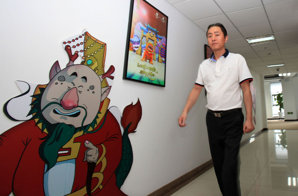 Wang Jin walks past an anime poster in the Program Production Center of China ACG Group Co., Ltd in Beijing, capital of China, April 19, 2012. (Xinhua/Meng Chenguang)