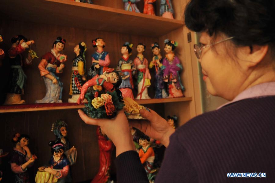 Li Lingxiu shows her clay sculptures in Lanzhou, capital of northwest China's Gansu Province, Nov. 20, 2012. The retired worker Li Lingxiu created 30 clay sculptures of characters in the ancient Chinese novel classic "A Dream of the Red Chamber". (Xinhua/Chen Bin) 