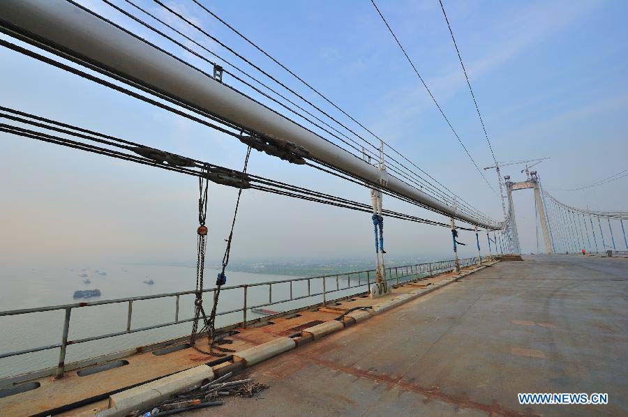 Photo taken on April 7, 2012 shows the Taizhou Yangtze River Bridge under construction in Taizhou, east China's Jiangsu Province. The bridge will open to traffic on Nov. 25. (Xinhua/Lu Zhinong) 
