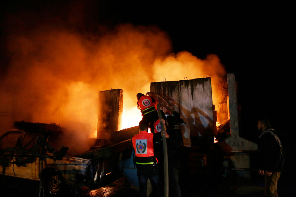 Firemen put out a fire caused by Israeli air strikes in Gaza City on Nov. 15, 2012. (Xinhua/AFP)