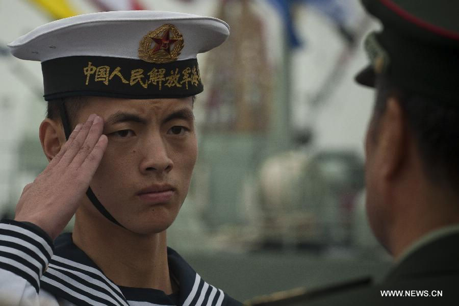 A seaman of the Chinese People's Liberation Army (PLA) salutes in the rotation ceremony in Hong Kong, south China, Nov. 25, 2012. The Chinese PLA garrison troops in the Hong Kong Special Administrative Region (HKSAR) conducted its 15th troop rotation on Sunday since it assumed Hong Kong's defense responsibility on July 1, 1997. (Xinhua/Lui Siu Wai) 