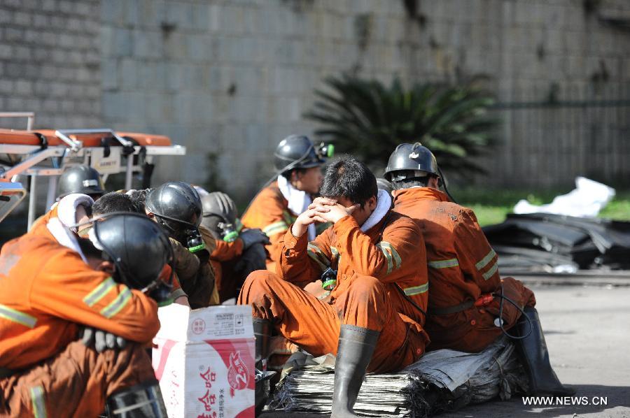 Rescuers take a rest before entering the shaft to continue rescue work at the Xiangshui Coal Mine in Panxian County of Liupanshui City, southwest China's Guizhou Province, Nov. 25, 2012. Nineteen miners were confirmed dead, and four others remain trapped after a coal-gas outburst hit the Xiangshui Coal Mine at 10:55 a.m. on Saturday.(Xinhua/Tao Liang) 