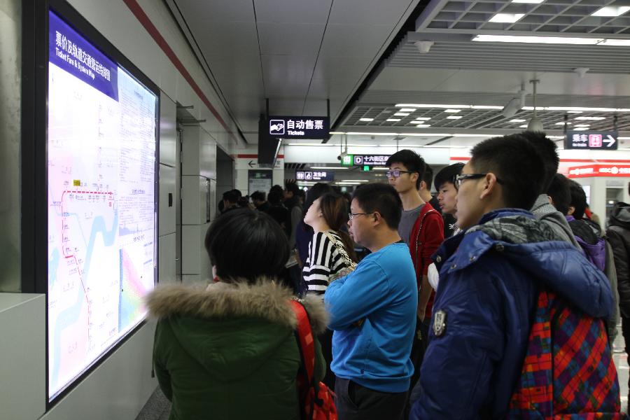 Passengers view a subway map at a station of Hangzhou Subway Line 1 in Hangzhou, capital of east China's Zhejiang Province, Nov. 24, 2012. Hangzhou Subway Line 1, the first subway in Zhejiang covering a distance of 47.97 kilometers, was put into a trial operation on Saturday after five years of construction. (Xinhua/He Xinchao) 