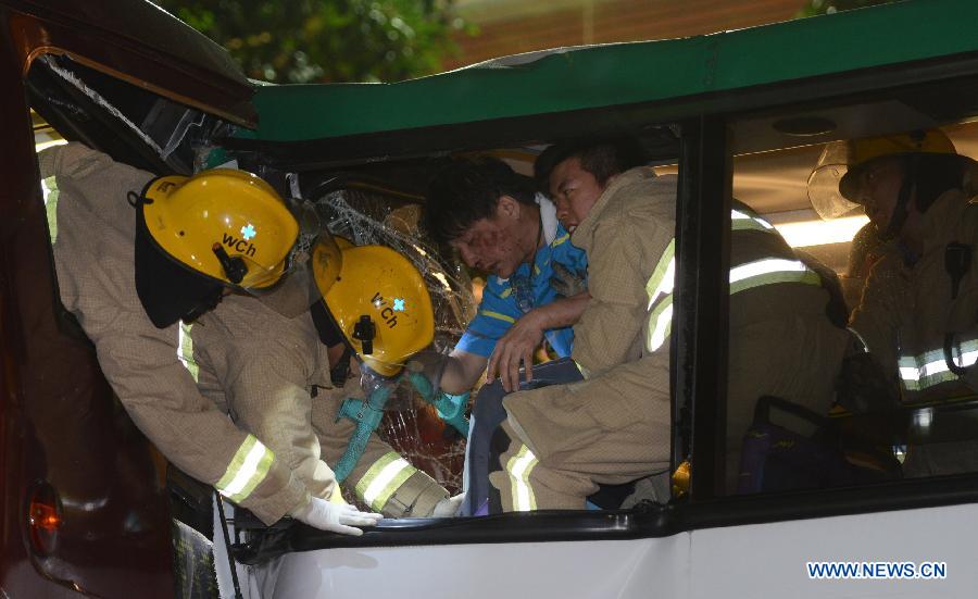 Rescuers save an injured passenger at a bus collision scene in Wan Chai, south China's Hong Kong, Nov. 27, 2012. At least 40 people were injured in a traffic accident involving three buses in Hong Kong on Tuesday evening, local authorities said. (Xinhua/Lo Ping Fai) 