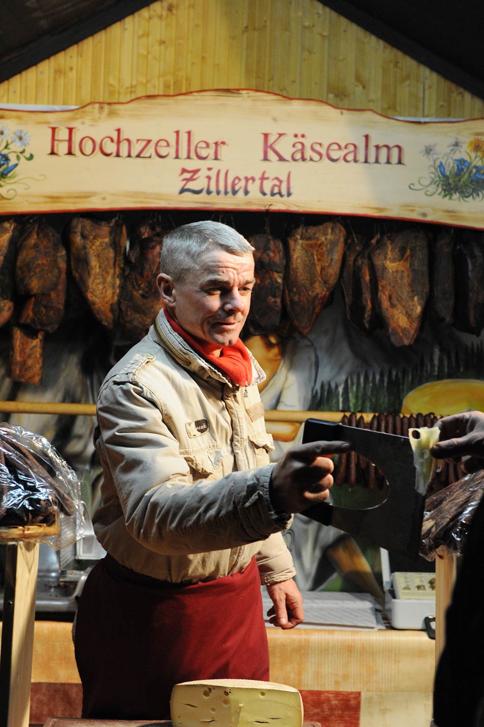 A shopkeeper sells German cheese in the Christmas market at the  Charlottenburg Palace, Berlin, capital of Germany, on Nov. 26, 2012. Since the Western traditional holiday Christmas is approaching, Christmas markets have opened one after another in Berlin. (Xinhua/Ban Wei)
