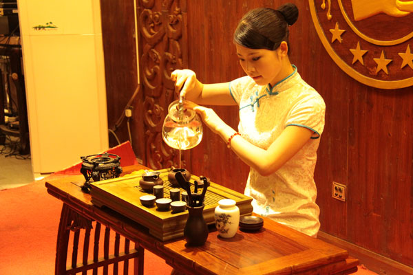 Lifting the kettle to pour the tea causes it to have a better color, fragrance, and flavor. (CRIENGLISH.com/Luo Chun)