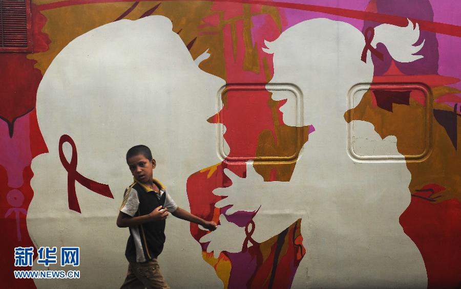 A child walks past a "Red Ribbon Express" train in Kolkata, India on July 27, 2012. "Red Ribbon Express" has visited 23 states to demonstrate knowledge, care and concern about HIV/AIDS in India. (Xinhua/AFP)