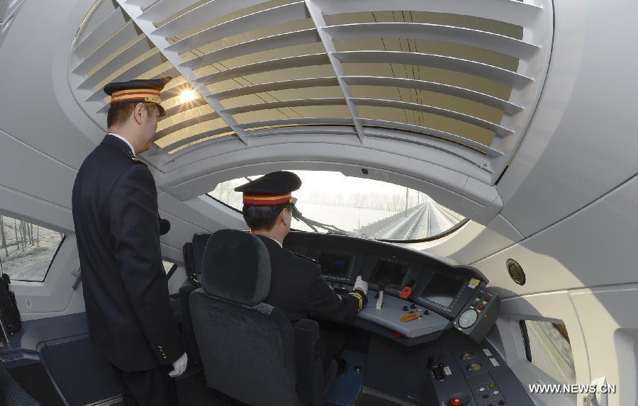 A driver works on a high-speed train leaving from Harbin, capital of northeast China's Heilongjiang Province, to Dalian, northeast China's Liaoning Province, Dec. 1, 2012.The world's first high-speed railway in areas with extremely low temperature, which runs through three provinces in northeastern China, started operation on Saturday. (Xinhua/Qi Heng)
