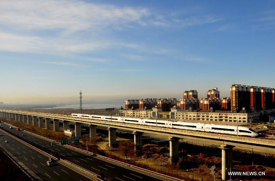 A high-speed train from Dalian North Railway Station to Harbin West Railway Station runs at the Jinzhou New District section in Dalian, northeast China's Liaoning Province, Dec. 1, 2012. The world's first high-speed railway in areas with extremely low temperature, which runs through Liaoning, Jilin and Heilongjiang provinces in northeastern China, started operation on Saturday. The railway links Harbin, capital of Heilongjiang , and Dalian, a port city in Liaoning. (Xinhua/Lv Wenzheng)