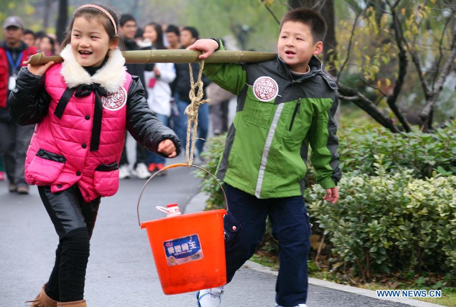 Children attend a large-scale fund raising public activity at the Xuanwuhu Park in Nanjing City, capital of east China's Jiangsu Province, Dec. 2, 2012. A fund of more than 100,000 RMB yuan(16,000 U.S. dollars), raised in the public activity, will be used to help relieve the difficulty of water drinking of residents in a mountain area of Yuanmou County, southwest China's Yunnan Province. (Xinhua/Wang Xin)