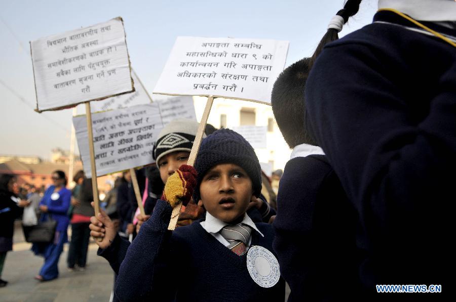 A visually disabled child holds a placard during a peace rally to mark the World Disabled Day in Kathmandu, Nepal, Dec. 3, 2012. (Xinhua/Sunil Pradhan) 