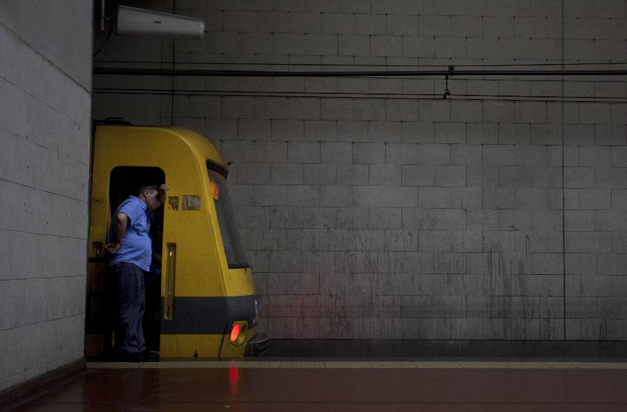 A subway employee is seen on an empty platform during a strike in Buenos Aires, capital of Argentina, on Dec. 3, 2012. As a result of disputes between union factions, vying for the representation of workers, the Tramway and Motorized Drivers Union (UTA) decreed a total stoppage in the six subway lines and Premetro, according to local press. (Xinhua/Martin Zabala) 