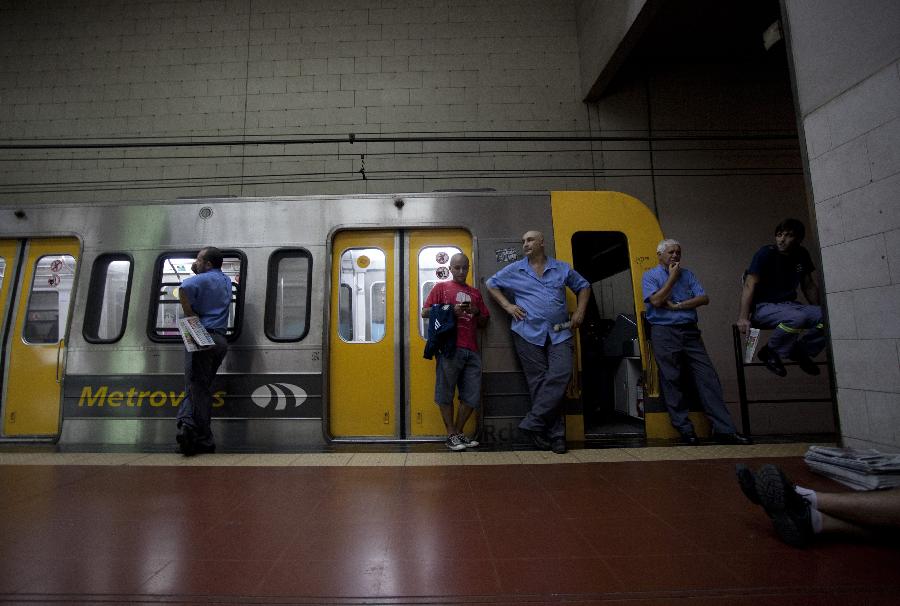 Subway employees are seen on an empty platform during a strike in Buenos Aires, capital of Argentina, on Dec. 3, 2012. As a result of disputes between union factions, vying for the representation of workers, the Tramway and Motorized Drivers Union (UTA) decreed a total stoppage in the six subway lines and Premetro, according to local press. (Xinhua/Martin Zabala) 