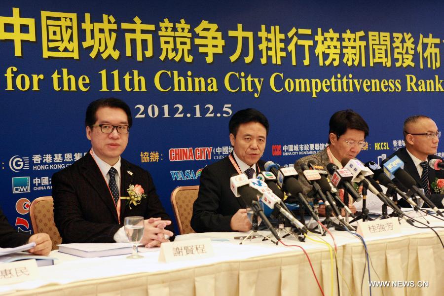 Gui Qiangfang (2nd L), president of China Institute of City Competitiveness, attends a media conference for the release of the 11th China City Competitiveness Ranking by the Institute in south China's Hong Kong, Dec. 5, 2012. The top three Chinese cities of the comprehensive competitiveness ranking are Hong Kong, east China's Shanghai Municipality and China's capital Beijing. (Xinhua/Jin Yi) 