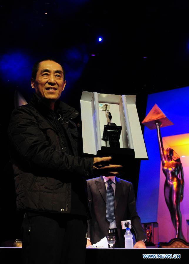 Chinese director Zhang Yimou receives a lifetime achievement award during the closing ceremony of the 35th Cairo International Film Festival in Cairo, Egypt, Dec. 6, 2012. (Xinhua/Qin Haishi)