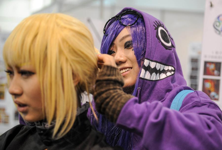 A cosplayer (R) puts on makeup for her teammate during the 1st Cosplay Cultural Festival in Hangzhou, capital of east China's Zhejiang Province, Dec. 9, 2012. The two-day festival closed on Sunday. (Xinhua/Han Chuanhao) 