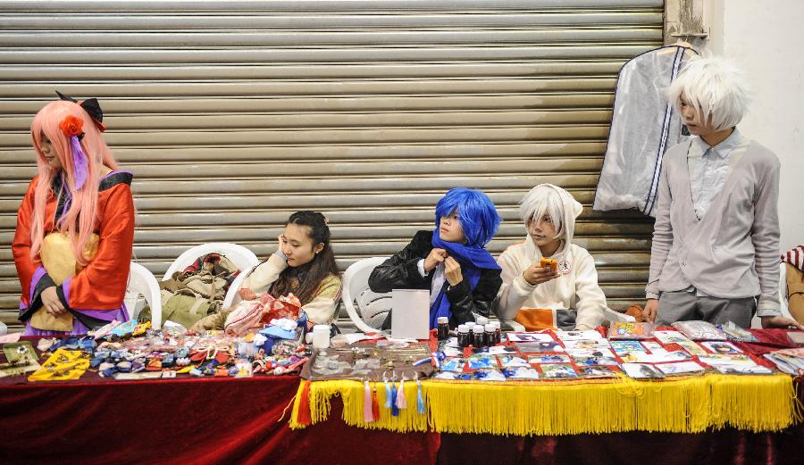 Cosplayers sell cartoon products during the 1st Cosplay Cultural Festival in Hangzhou, capital of east China's Zhejiang Province, Dec. 9, 2012. The two-day festival closed on Sunday. (Xinhua/Han Chuanhao)
