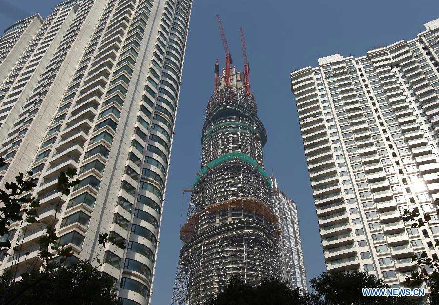 Photo taken on Dec. 8, 2012 shows the Shanghai Tower (C), a skyscraper under construction, in Pudong, east China's Shanghai Municipality. The Shanghai Tower is expected to reach 632 meters in height and start service in 2015. (Xinhua/Pei Xin)