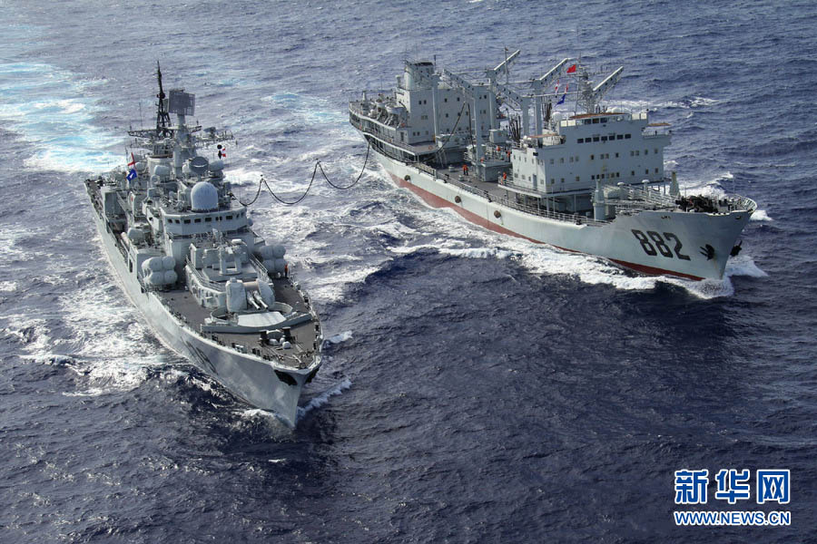The "Poyang Lake" comprehensive supply ship (R) provides maritime comprehensive supply to the "Ningbo" guided missile frigate (L) on December 6, 2012.(Xinhua/Ju Zhenhua)